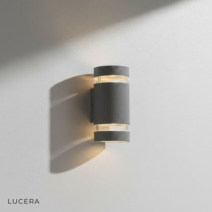 Warm white LED glow from Reese sconce on a cozy porch with wooden siding