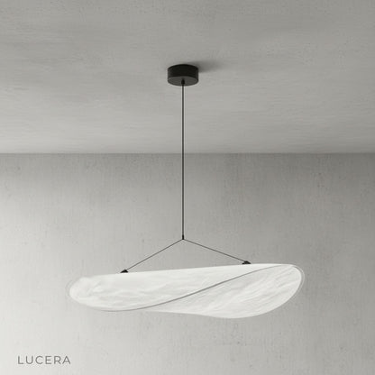 Eridanus pendant light illuminating a cozy dining nook with warm ambient light