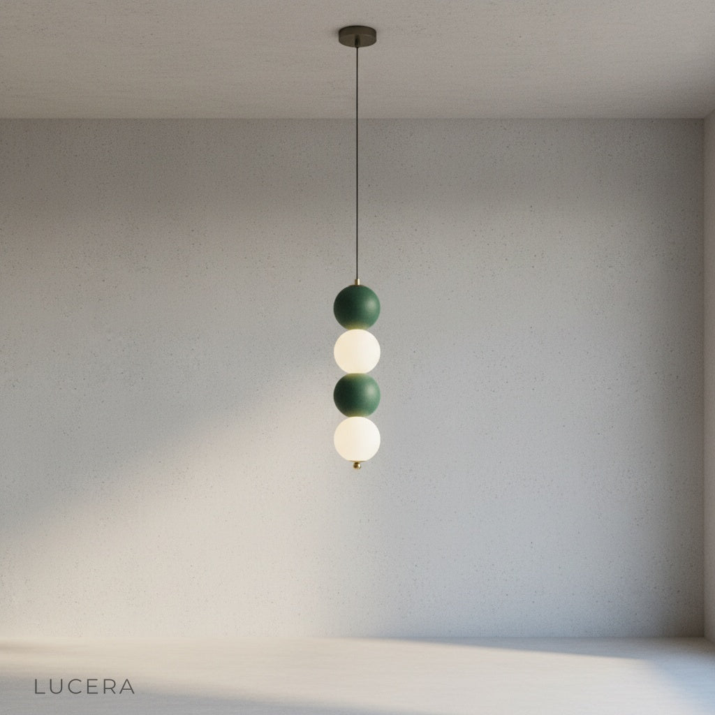 Sogno pendant light with brass accents illuminating a cozy reading nook with soft ambient shadows