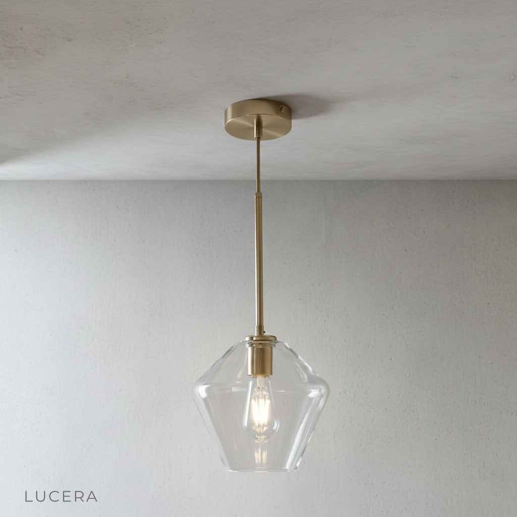 three-light geometric pendant fixture glowing warmly in an entryway
