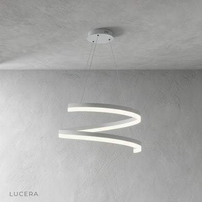 Warm ambient light from Hypnotize pendant illuminating minimalist bedroom corner