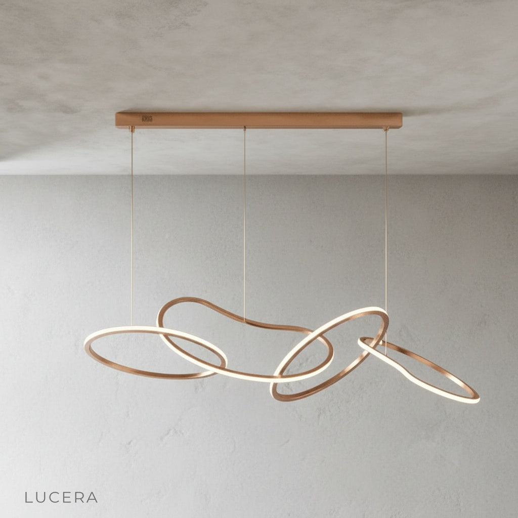 Yakitori chandelier in brushed steel finish hanging in minimalist dining room setting