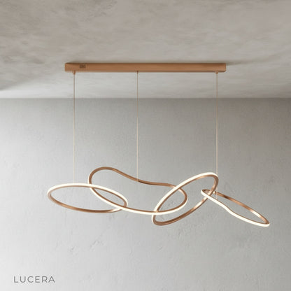 Yakitori chandelier in brushed steel finish hanging in minimalist dining room setting