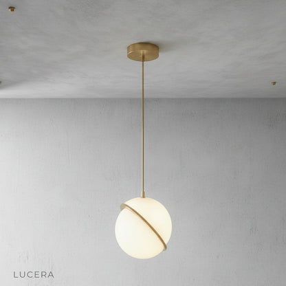 Igneous pendant light illuminated sphere casting soft light in cozy reading corner