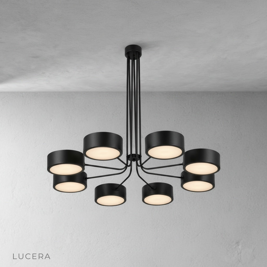 detail of curved brass arm joint and candle-style bulb on Lacrima chandelier