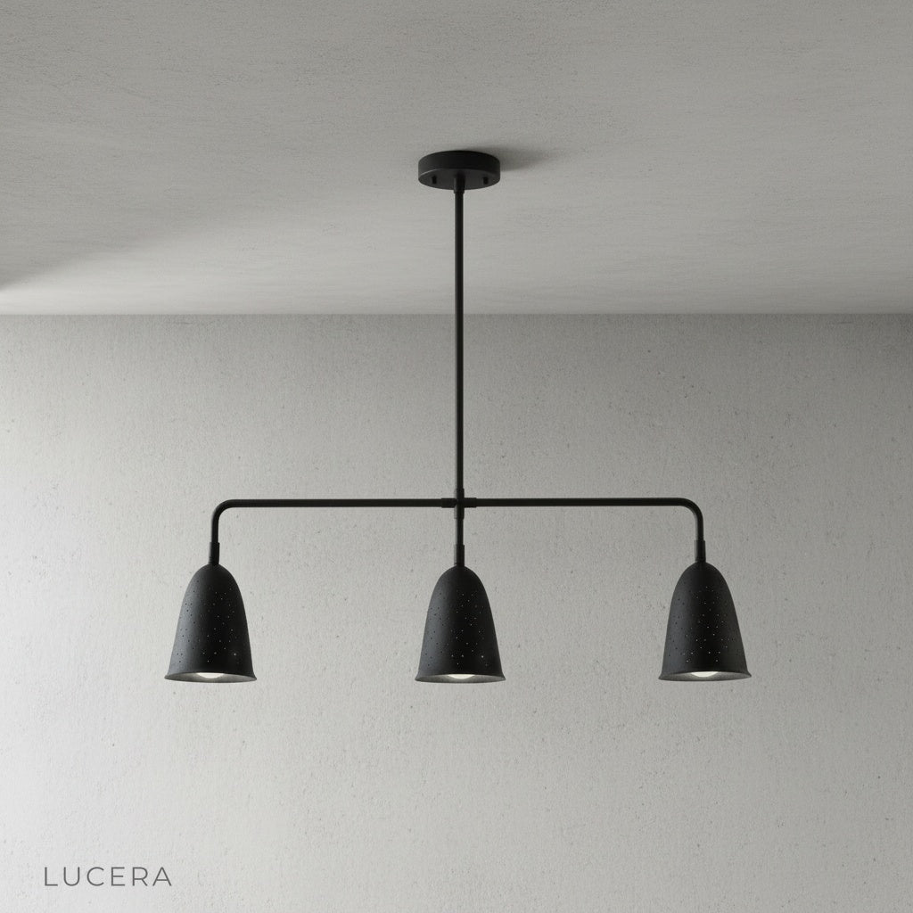 whimsy linear chandelier glowing softly above kitchen island at dusk