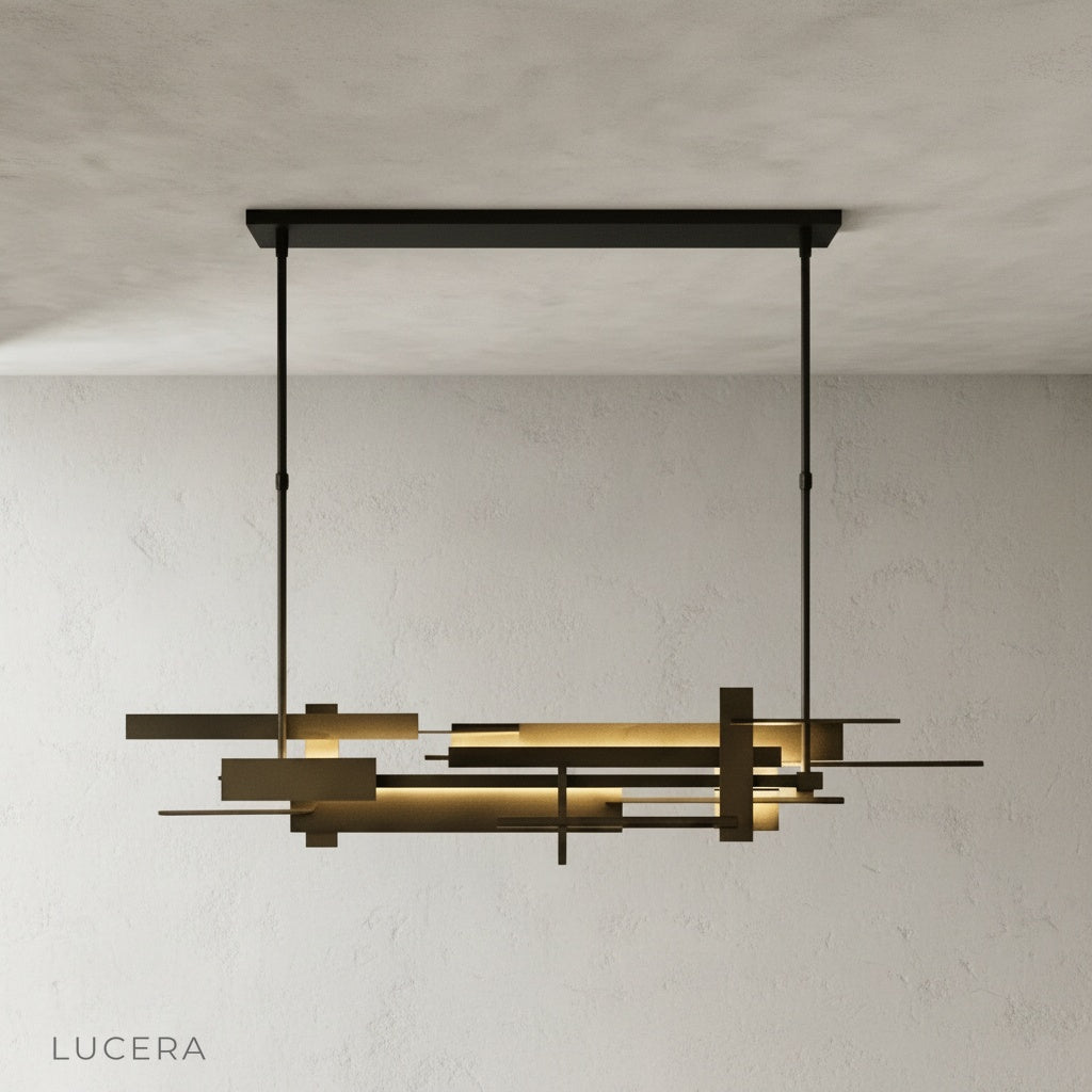 Cassiopeia chandelier hanging over kitchen island with minimalist stools