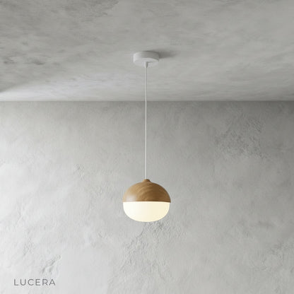 wood-look pendant light casting warm light over a cozy bedside nook with neutral bedding