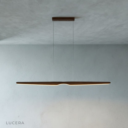 angled view of Ember wood pendant light highlighting its slim profile and warm wood tones