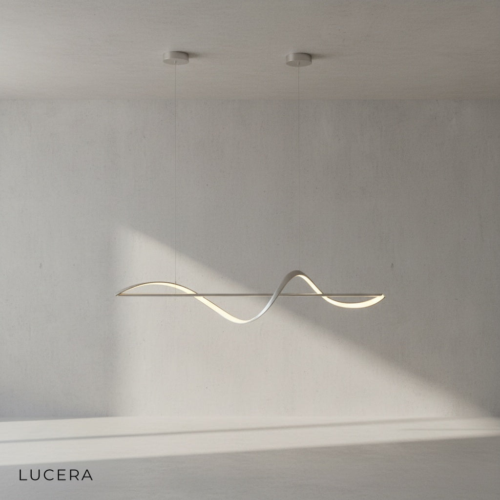Skuld Wave LED chandelier glowing warm light in minimalist dining room at dusk