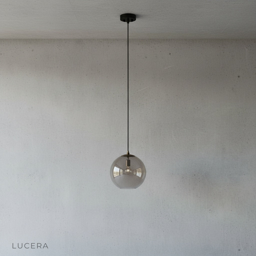 Multicolored stained glass sphere pendant light suspended in a modern minimalist interior