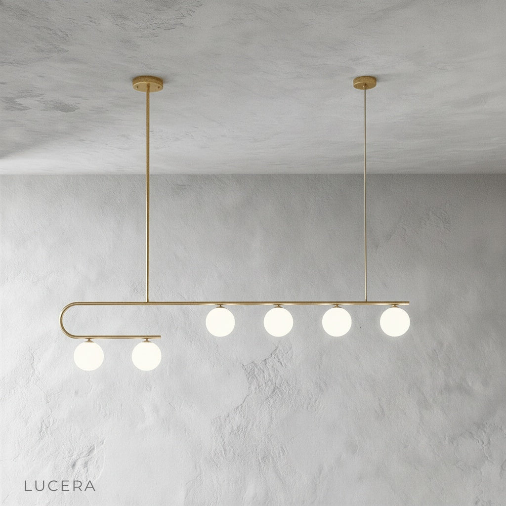 nephrite linear chandelier in matte black finish with five pendant lights over dining table