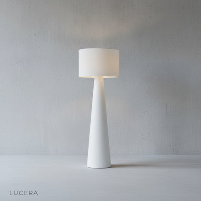 Quarters Floor Lamp turned on at dusk casting non-glaring light across a bedroom reading nook with wooden floor