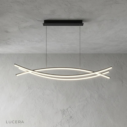 Eterno Chandelier hanging over dining table with soft diffused light in contemporary setting