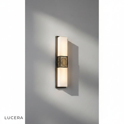 elegant Choral sconce mounted above a bathroom vanity with warm 3000K glow