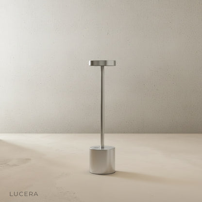 Sinkhole Table Lamp casting soft ambient glow on dark console at night
