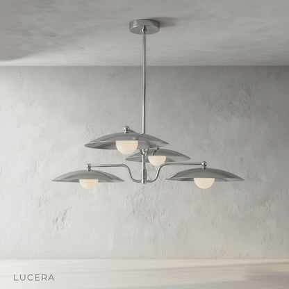 Stellar Brass Chandelier hanging above a kitchen island in a bright contemporary space