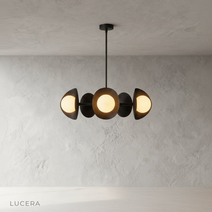 Lambrusco Chandelier with warm ambient light glowing above a kitchen island