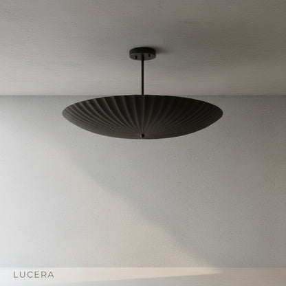 Overhead view of the fluted brass pendant light against a neutral studio backdrop