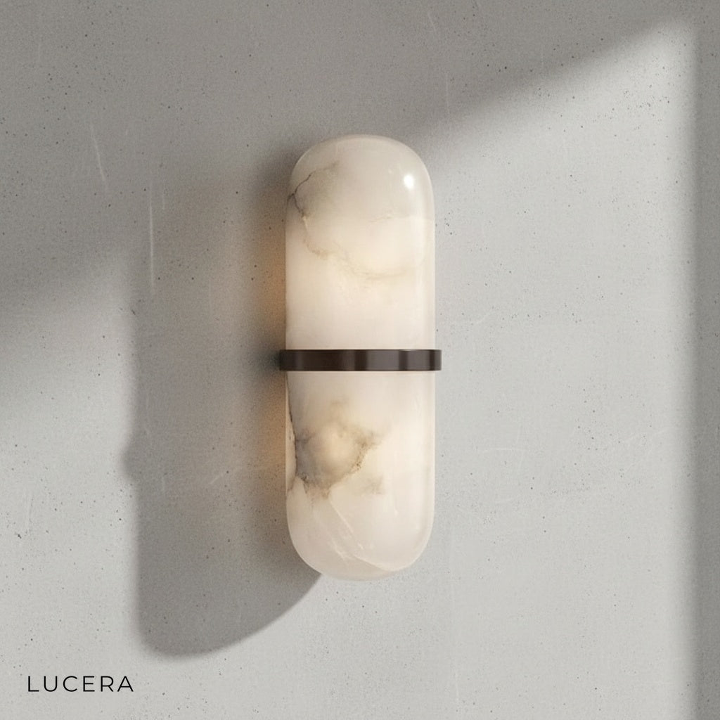 Elliptical marble sconce with neutral white light in minimalist hallway