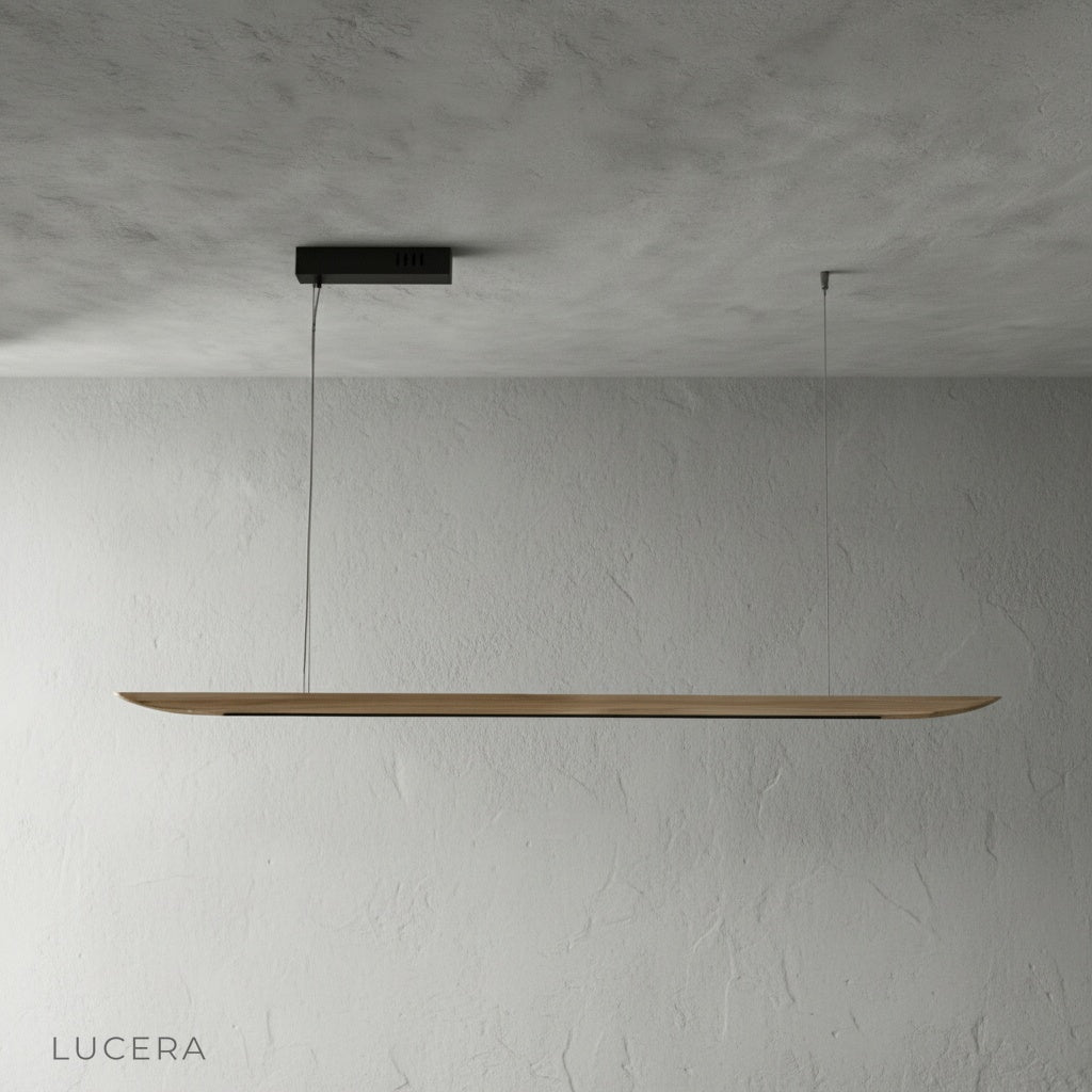 Side angle of the Fauvist pendant light in a studio, highlighting its slim silhouette and matte wood finish