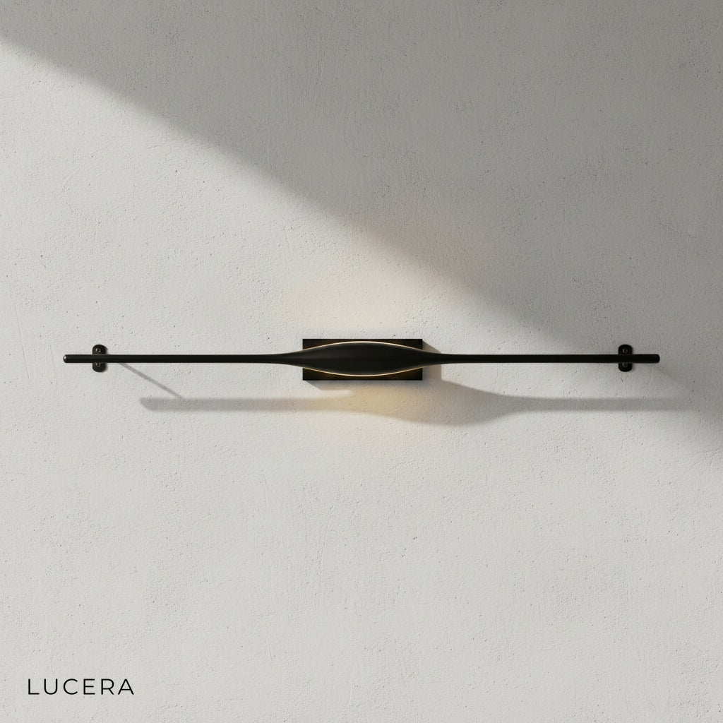 Elan wall lamp above a modern bed in a serene bedroom with soft ambient lighting