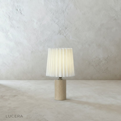 Pandora Table Lamp on rustic oak nightstand beside reading chair with open book and warm ambient glow