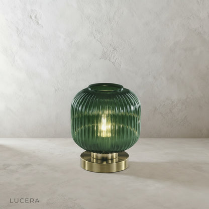 divine table lamp on minimalist nightstand next to folded linen bedding