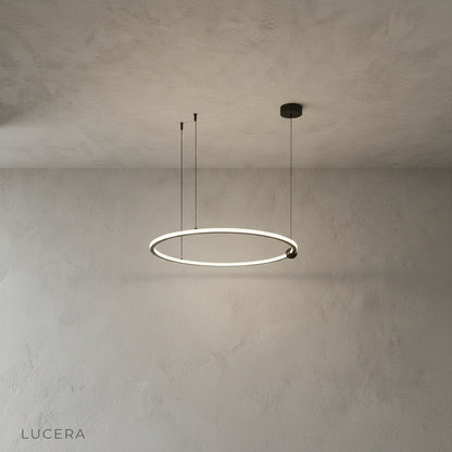 Vaughn Chandelier glowing warm light in contemporary dining room with wooden table