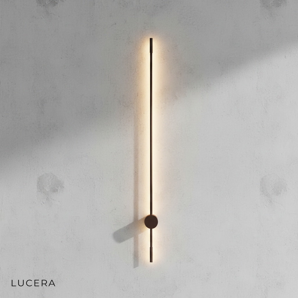 Rinforzando wall lamp in matte black finish against grey studio backdrop
