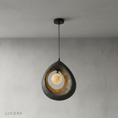 Kelp pendant light hanging above wooden dining table in modern kitchen