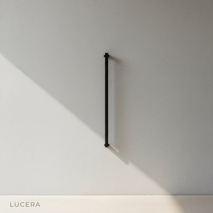 studio view of matte black metal outdoor fixture with frosted glass panel