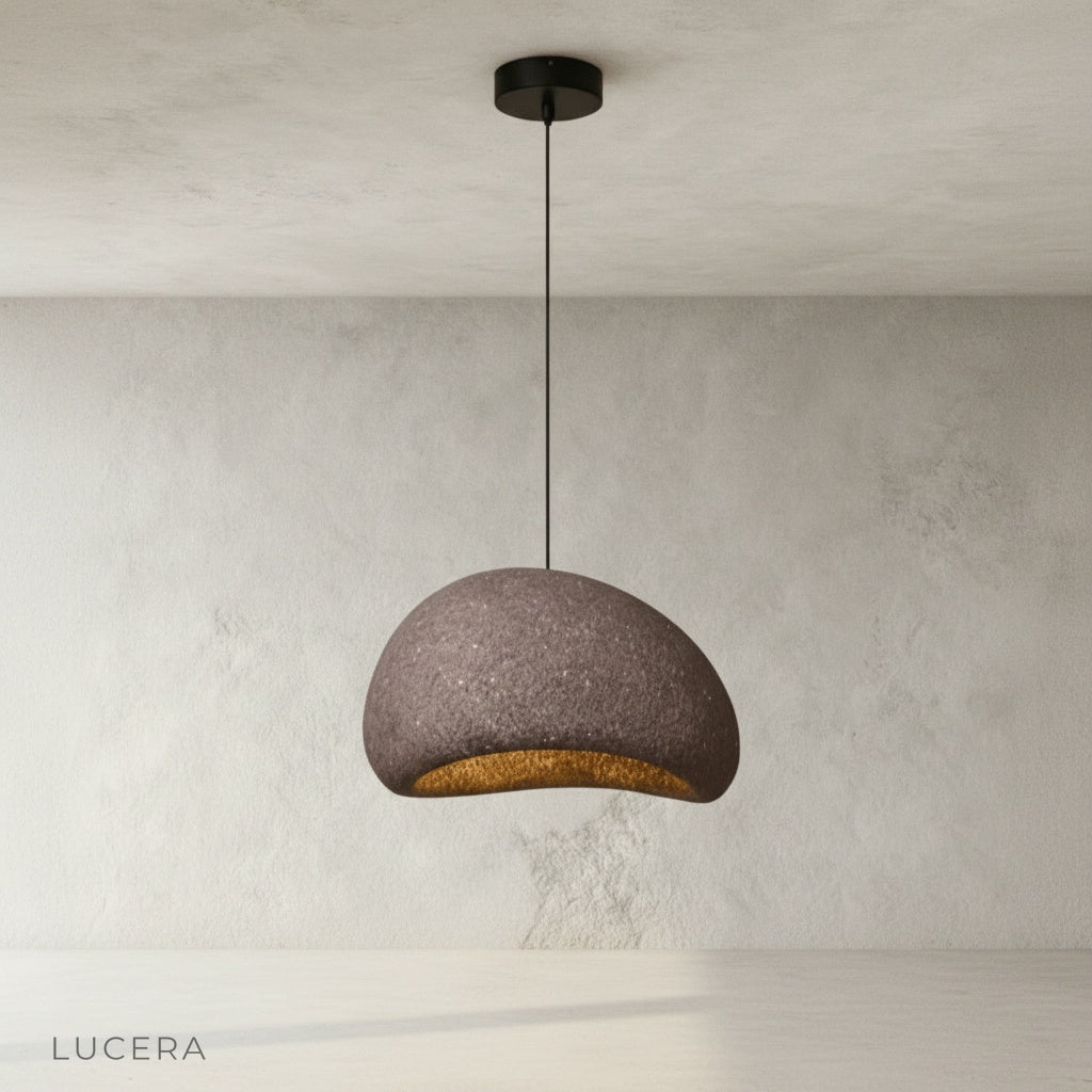 ambient evening shot of sand pendant light glowing in cozy reading corner