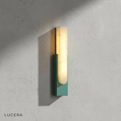Elegant marble sconce casting soft shadows on textured plaster wall