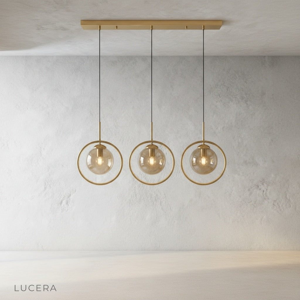 Caelus pendant light gold ring and glass sphere suspended from black ceiling cord