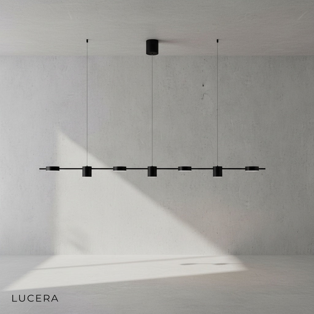 Rind pendant lamp suspended at varying heights in minimalist hallway