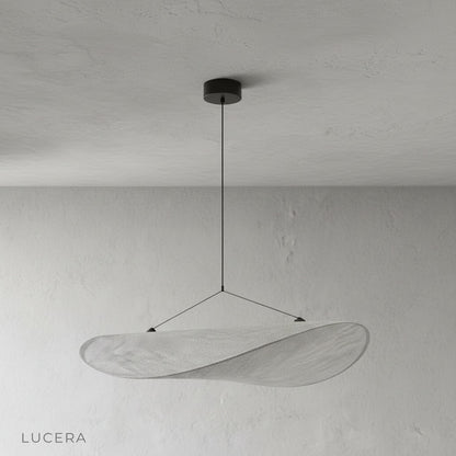 Eridanus pendant light in minimalist bedroom setting casting soft evening glow