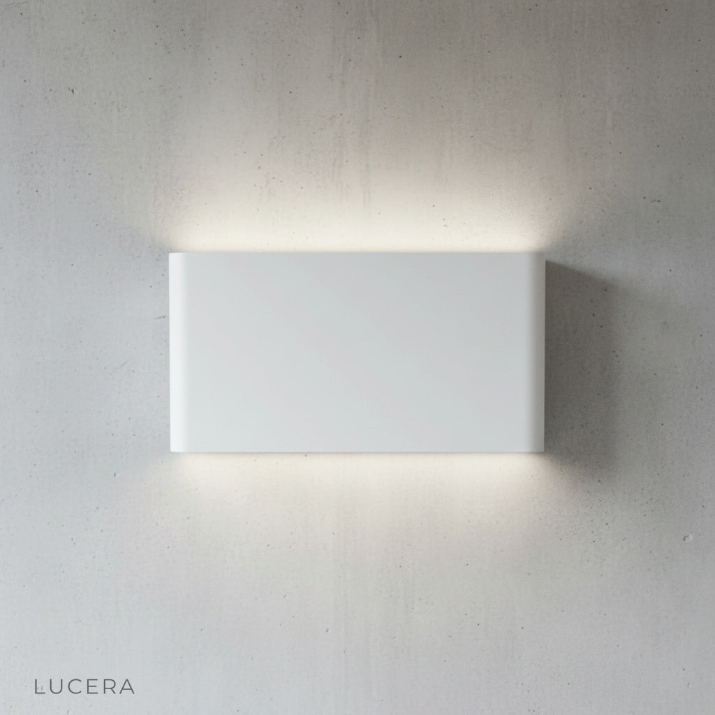 Lucera Cadmium wall lamp mounted on textured concrete wall