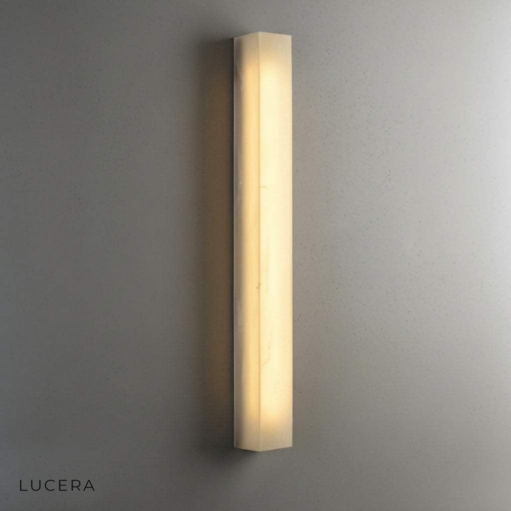 copper and marble wall lamp illuminating hallway with elegant minimalist decor