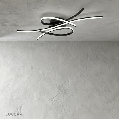 minimalist ceiling light with fluid curved LED lines in neutral interior