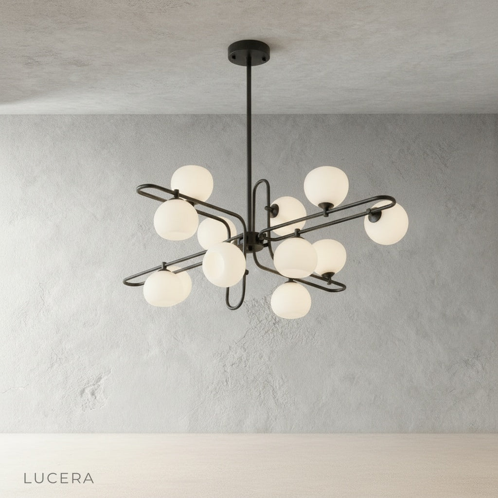 litany chandelier in black finish with warm glass globes