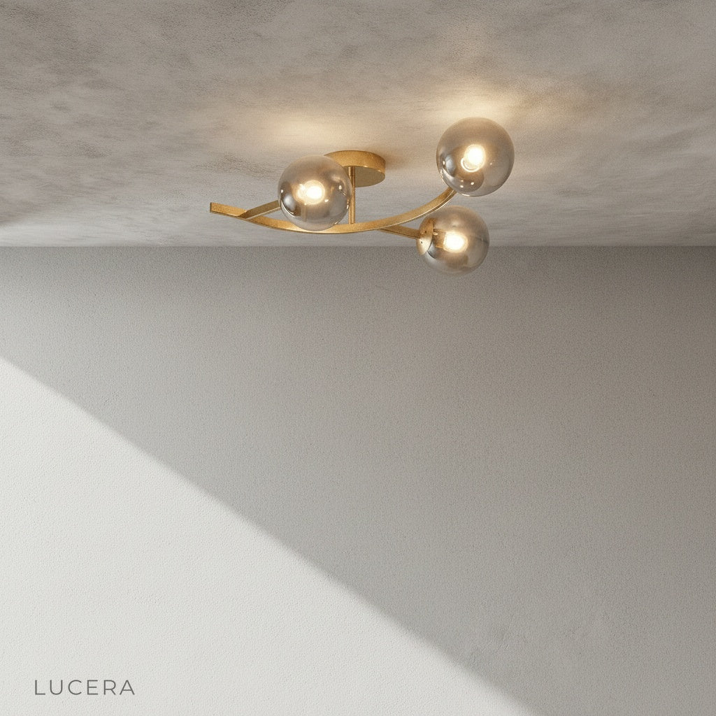 black iron ceiling fixture with three glass globes in bright studio