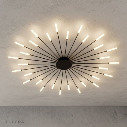 overhead angle of Karma chandelier with all LED arms extended in minimal studio setting