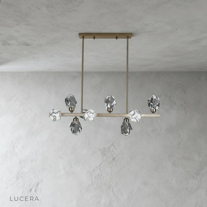 cassia chandelier hanging in elegant dining room with warm ambient lighting and crystals sparkling