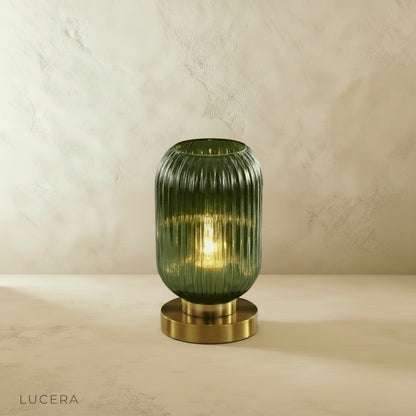eclat table lamp glowing softly on marble sideboard in modern hallway