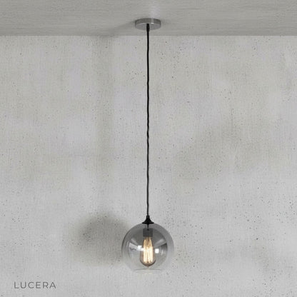 Alternate view of green gold pendant light with soft diffused glow in bright studio light