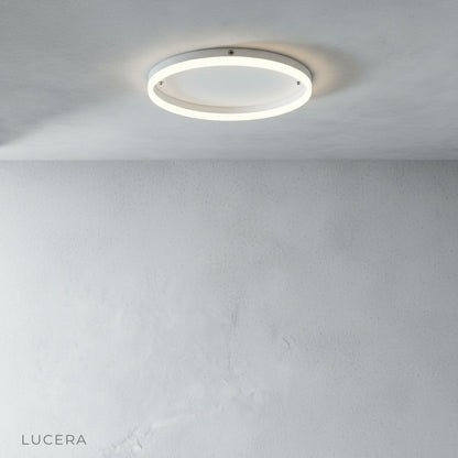 sleek round ceiling fixture in bright modern office hallway