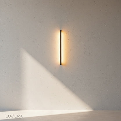 pair of linear LED wall lamps flanking modern front door at night