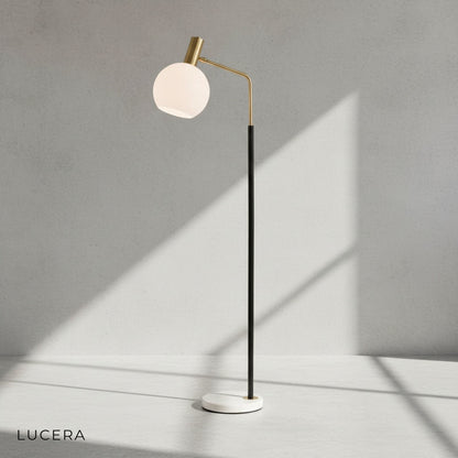 Luxury floor lamp beside velvet armchair in elegant lounge