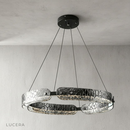 black iron chandelier hanging over contemporary wooden dining table